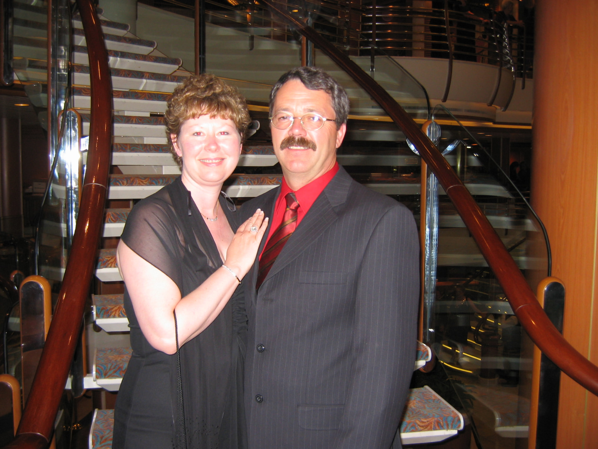 Shauna and Richard LeBlanc dressed for a formal evening on a cruise ship staircase